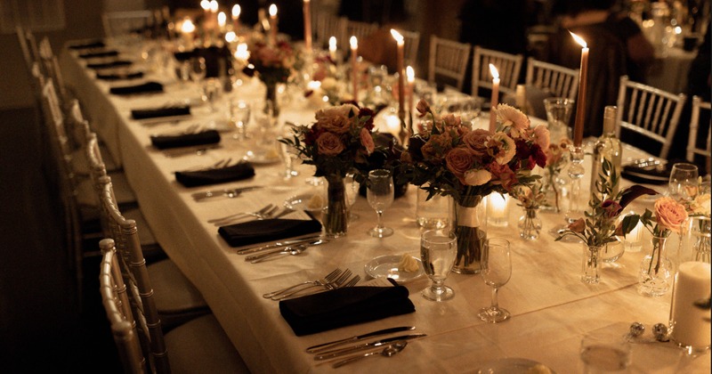 Elegant dining table adorned with candles and flower arrangements