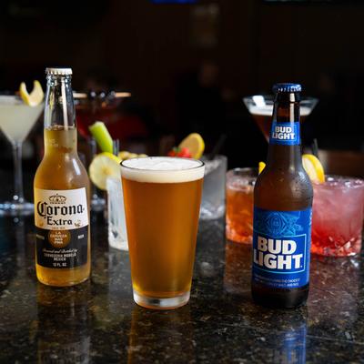 Assorted drinks displayed on a bar counter.