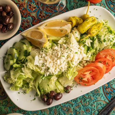 Greek Salad, with lettuce, olives, cucumber, tomato, pepperoncini, and feta.