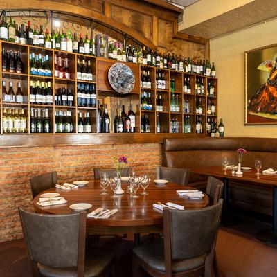 Dining table and a wine rack in the background.