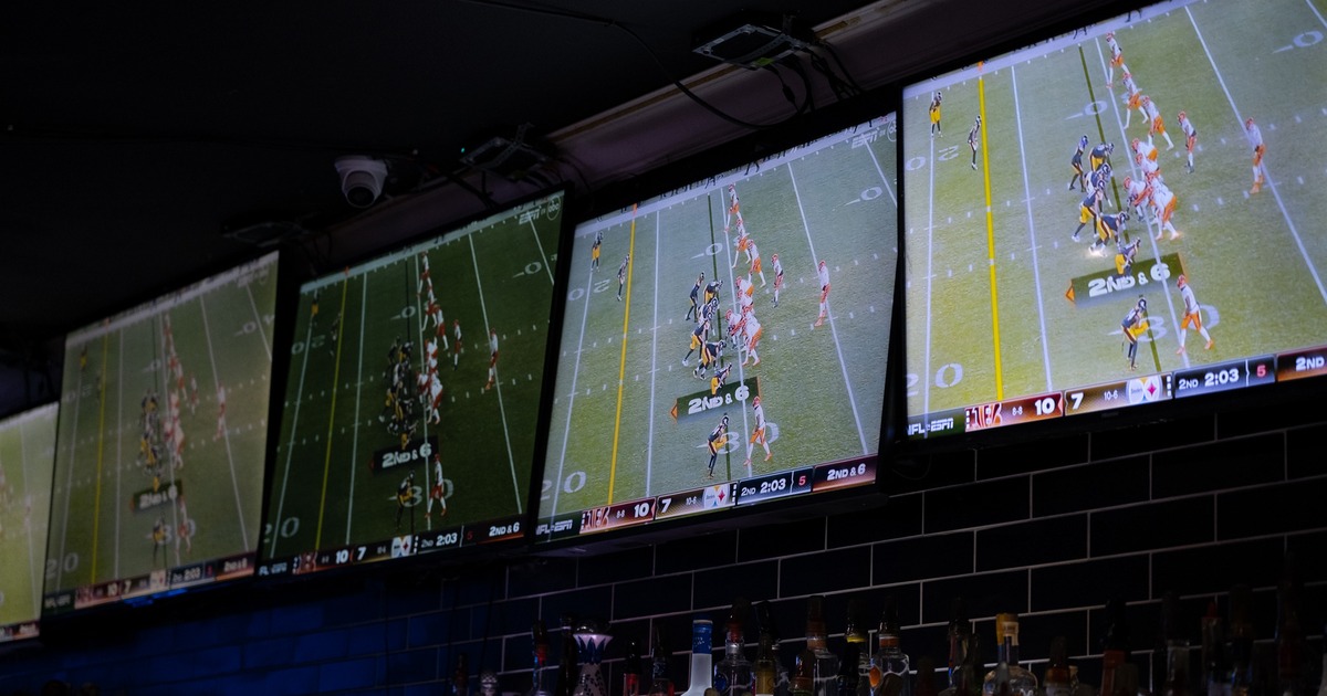 Tv screens above bar
