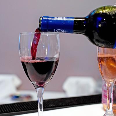 Red wine being poured into a glass.