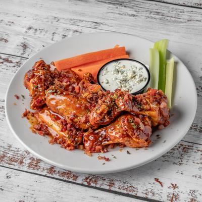 Pub wings with celery, carrots, and a sauce