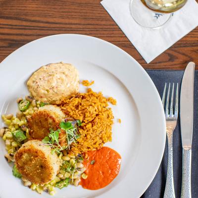 Crab cakes with sauces for dipping, rice and sweet corn