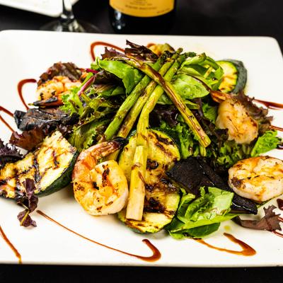 Grilled shrimp salad with mixed greens and grilled veggies.