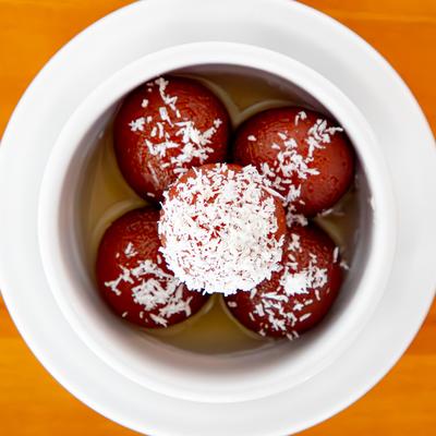 Fried dough balls made from milk solids and semolina soaked in a sugar syrup.