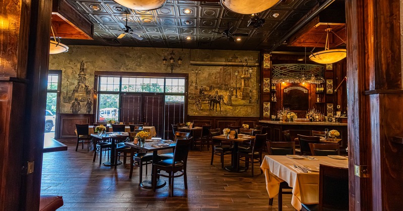 Interior, tables and chairs with plates and tableware