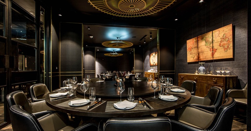 Inside, round table ready for guests, decoration on the walls