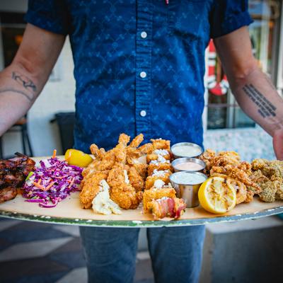 Person holding a Patron Platter.