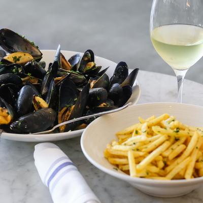 Mussels plate, French fries and a glass of white wine.
