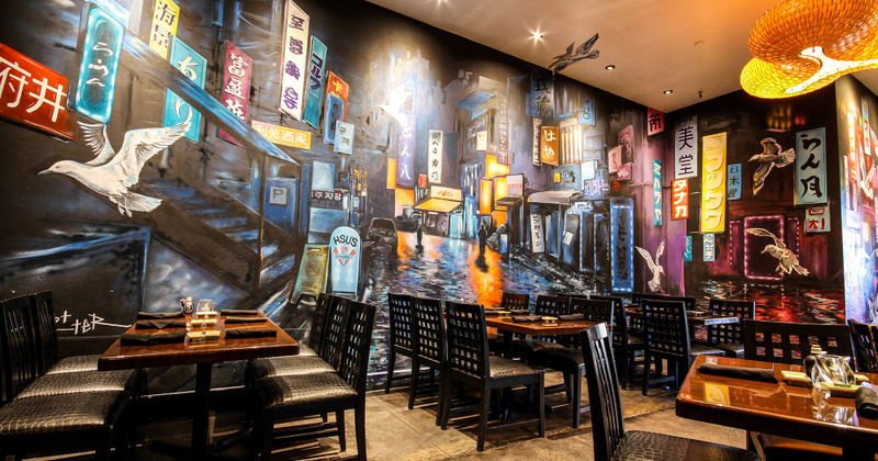 Interior, tables and seats, mural wall art depicting a city street at night