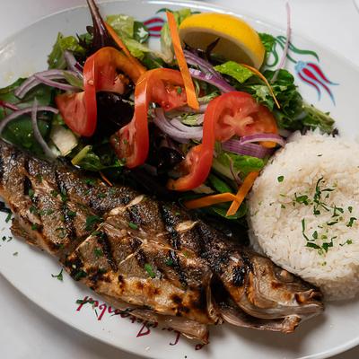 Grilled whole fish, with rice and veggies.