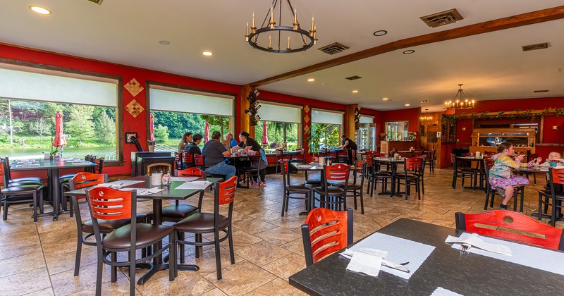 Interior space, dining area with set tables, guests enjoying their food and drinks