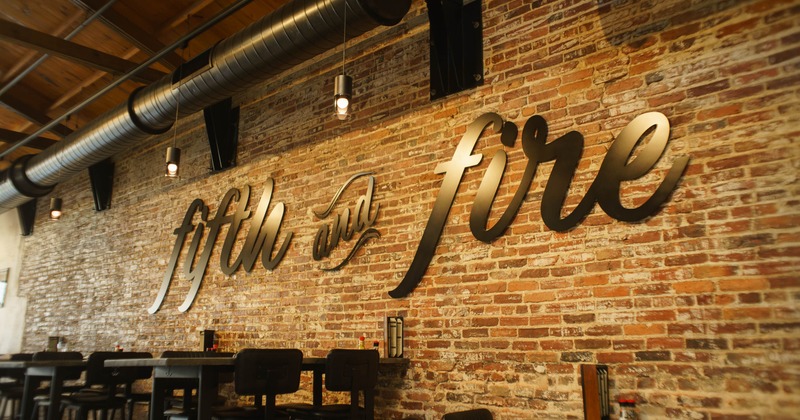 Interior, seating area with a big logo on the brick wall