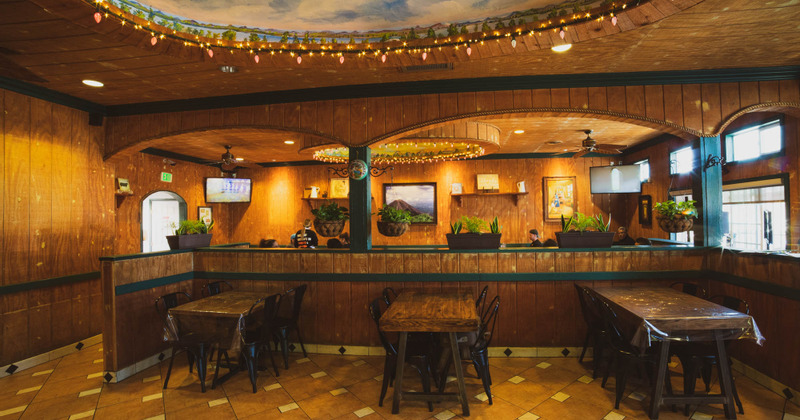 Interior, tables and chairs, restaurant decoration, staff member working, guests sitting