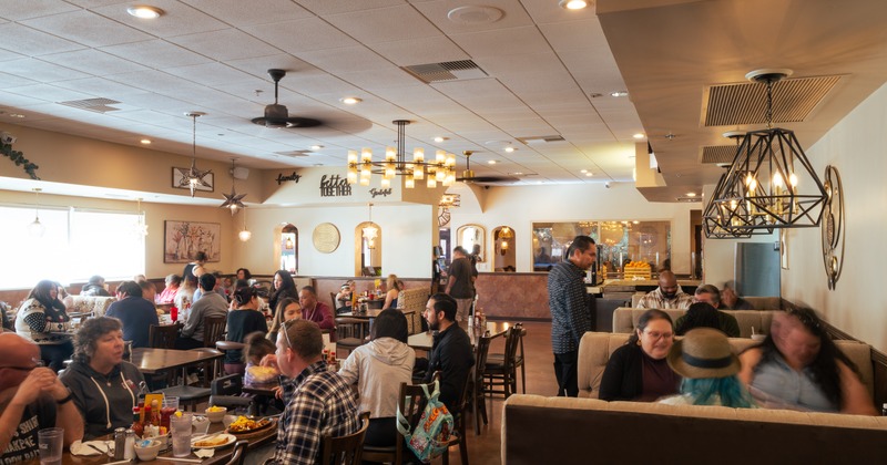 Diner area, tables, chairs, booths, people seating, eating