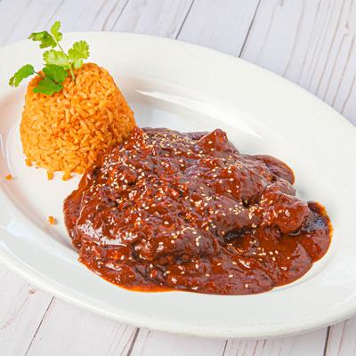 Chicken in Mole sauce, served with rice.