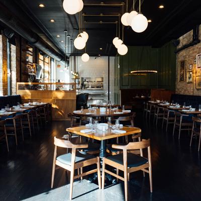 Dinning area. tables with glassware and utensils, banquette seating