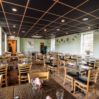 Interior of spacious and cozy dining area with set dining tables.