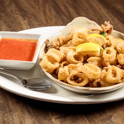 Fried calamari with marinara sauce sauce on the side.