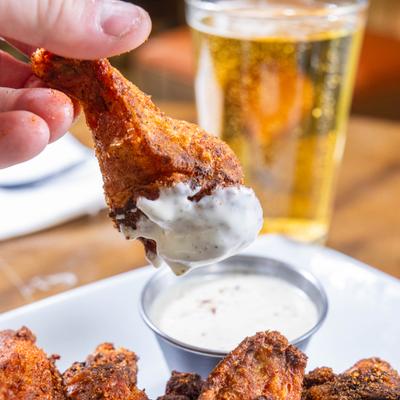 Chicken wing dipped in sauce.