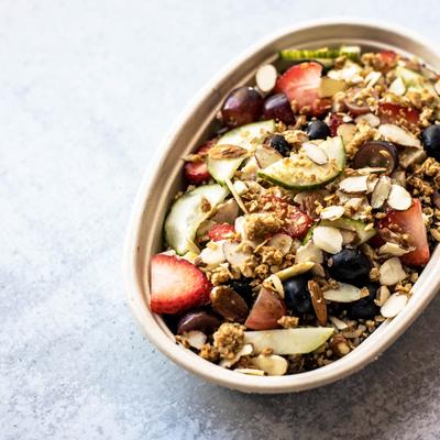 A salad with almonds, cucumbers, strawberries, black olives and quinoa