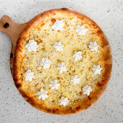 Cheese pizza with ricotta served on a wooded board.