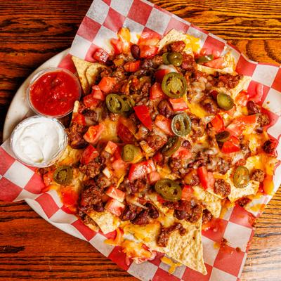 Loaded Nachos with chili, cheese, jalapenos, tomatoes, sour cream and salsa.