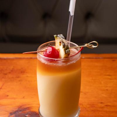Pina Colada garnishes with a slice of pineapple and a cherry.