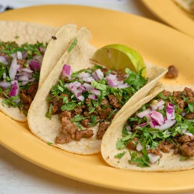 Beef tacos, with onion and cilantro.