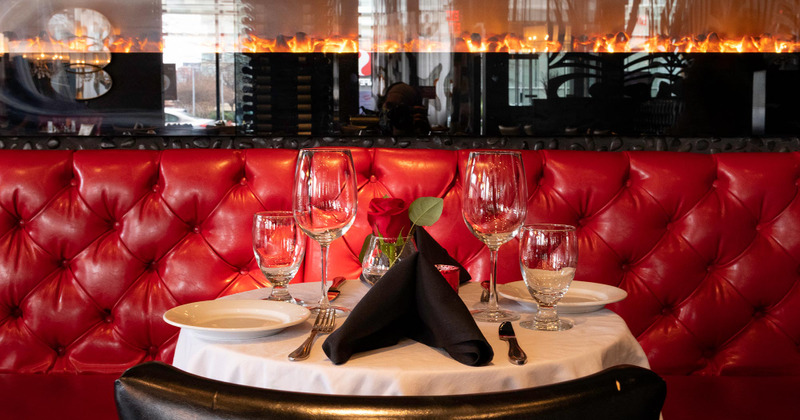 Interior, set dining table with a chair and button tufted red leather seating