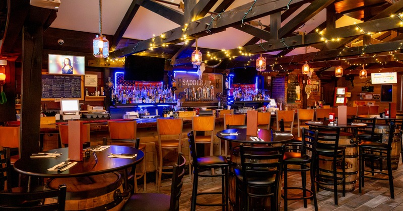 Interior, high seating and bar area, high round tables with stools, bar in the back