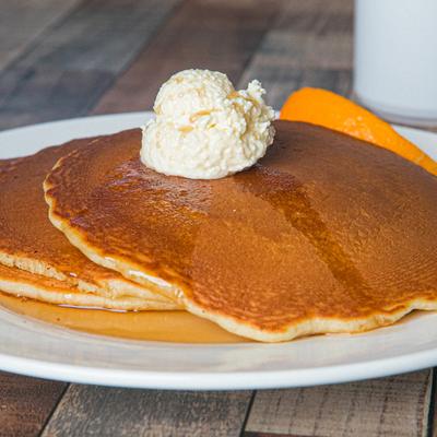 Pancakes, with butter, and maple syrup.