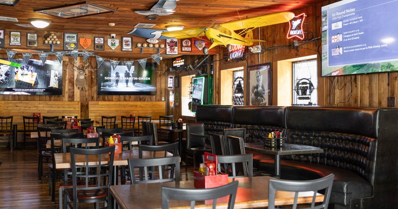 A cozy sports bar with wooden interior, colorful signs