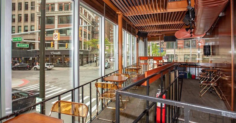 Interior, lined up tables and chairs by the windows