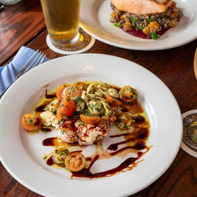 Caprese salad served with a glass of beer.