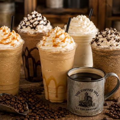 Variety of blended frappés topped with whipped cream and a cup of black coffee.