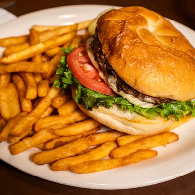 Cheeseburger with tomato, lettuce and a side of fries.
