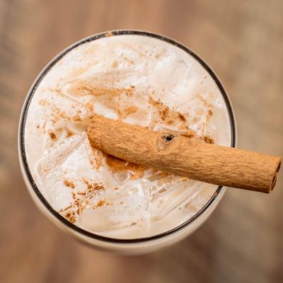 Horchata garnished with cinamon stick, top view.