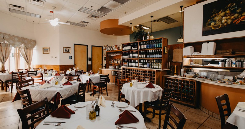 Interior, wide view of dining area, wine racks