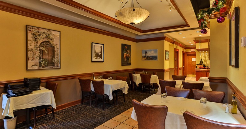 Interior, dining area, white cloth tables with chairs, Christmas decoration