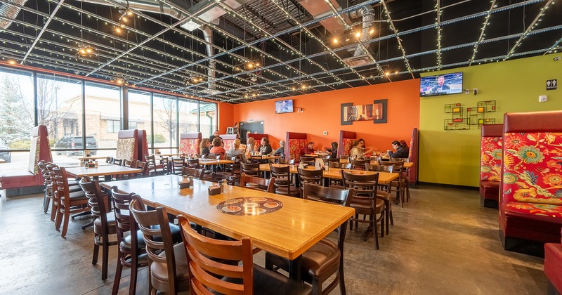 Interior space, dining area, guests chatting and enjoying their food and drinks