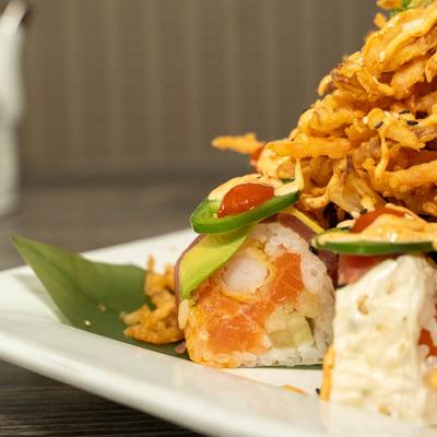 Tempura veggies, surrounded by sushi rolls.