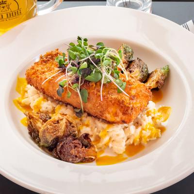 Salmon served on coconut rice, with mango curry and Brussels sprouts