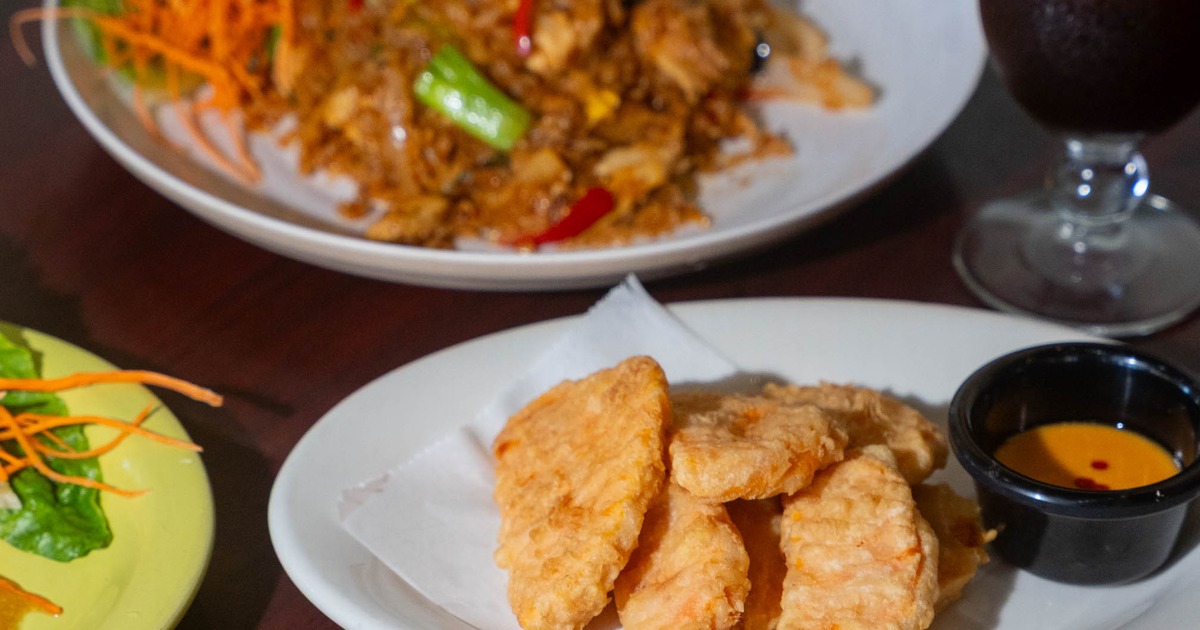 Table spread featuring serving of fried sweet potato and a plate of fried rice