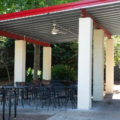 Patio cover with tables and chairs.