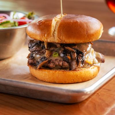 Mushroom Swiss burger with a side salad.