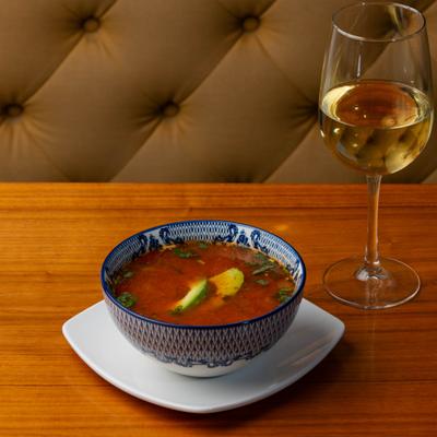 Caldo chipotle soup, served with glass of white vine.