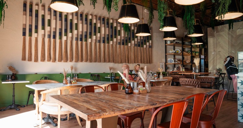 Cozy café interior with wooden tables and red chairs