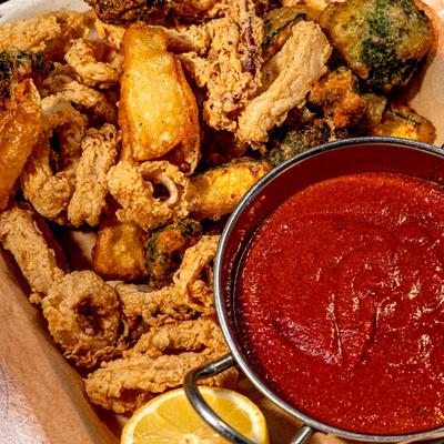 Fried calamari and zucchini served with marinara and a lemon half.